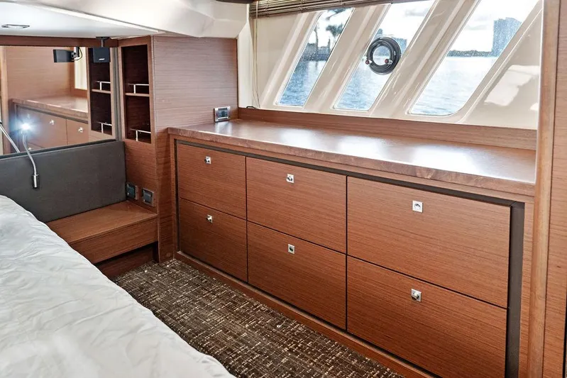  Yacht Photos Pics Luxurious interior of 2015 Sea Ray 510 Fly yacht with wooden cabinetry and large windows.