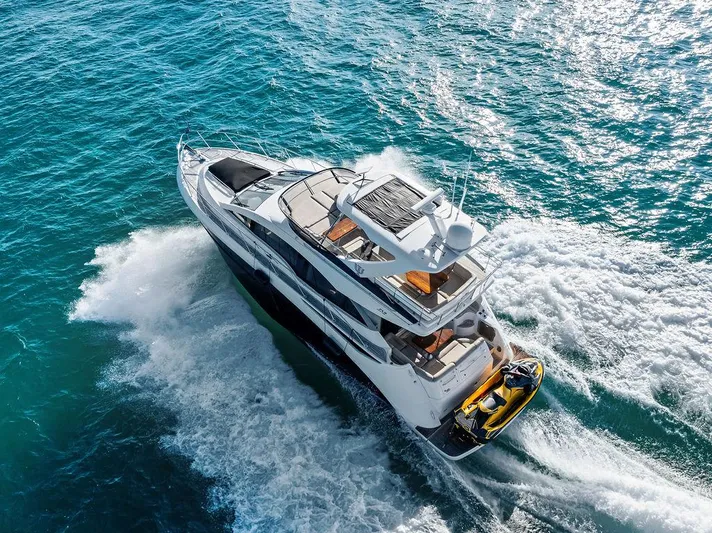  Yacht Photos Pics 2015 Sea Ray 510 Fly yacht cruising on open water, aerial view.