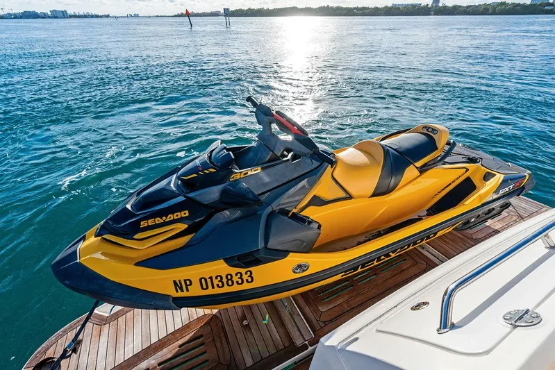  Yacht Photos Pics Yellow Sea-Doo jet ski on a 2015 Sea Ray 510 Fly yacht, docked on calm water.