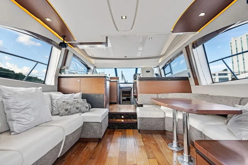  Yacht Photos Pics Luxurious interior of 2015 Sea Ray 510 Fly yacht with modern seating and wood flooring.