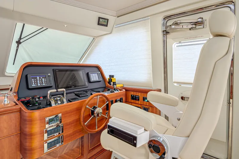 Frivolous Yacht Photos Pics Luxurious 2019 Hunt Yachts motor yacht helm with modern navigation equipment and plush captain's chair.