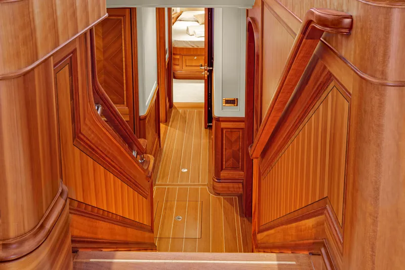 Frivolous Yacht Photos Pics Luxurious wooden interior of 2019 Hunt Yachts motor yacht, featuring elegant stairway and hallway.