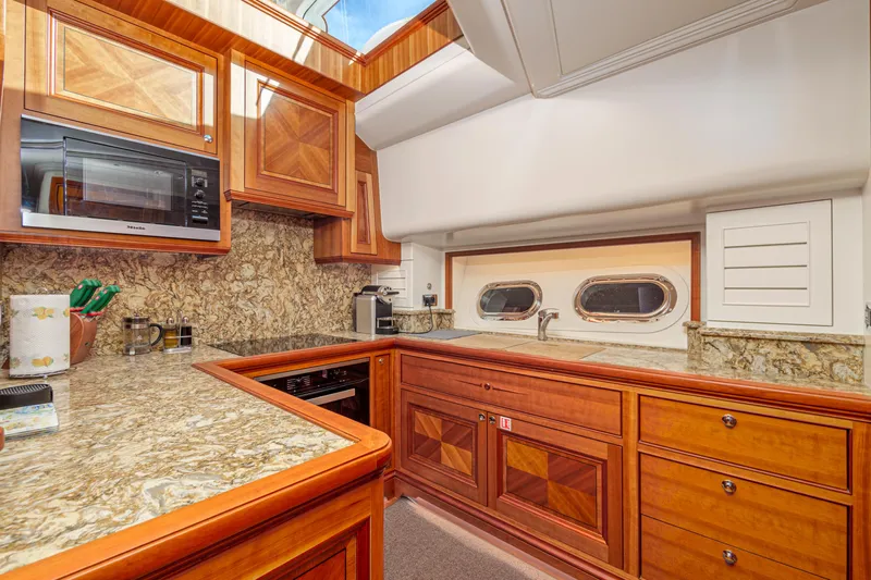 Frivolous Yacht Photos Pics Luxurious 2019 Hunt Yachts motor yacht kitchen with wood cabinetry and granite countertops.