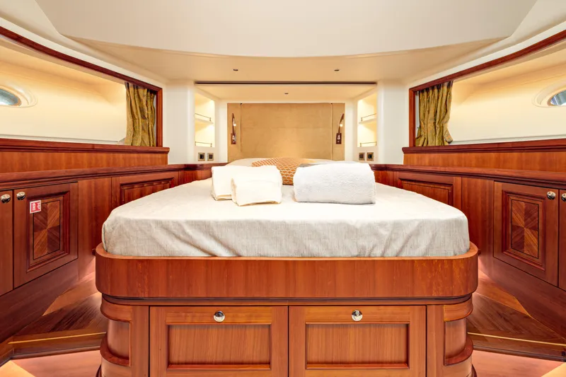 Frivolous Yacht Photos Pics Luxurious 2019 Hunt Yachts motor yacht bedroom with elegant wood finish and cozy bedding.