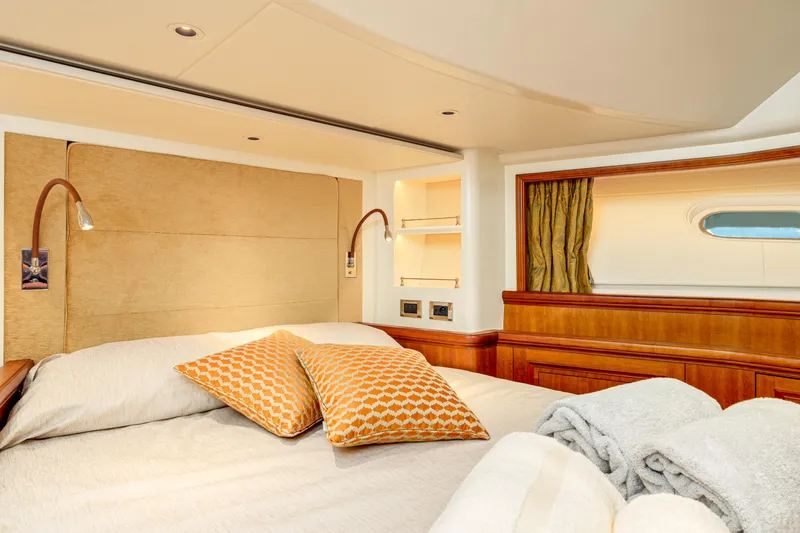 Frivolous Yacht Photos Pics Luxurious 2019 Hunt Yachts motor yacht bedroom with cozy bedding and elegant wood finishes.