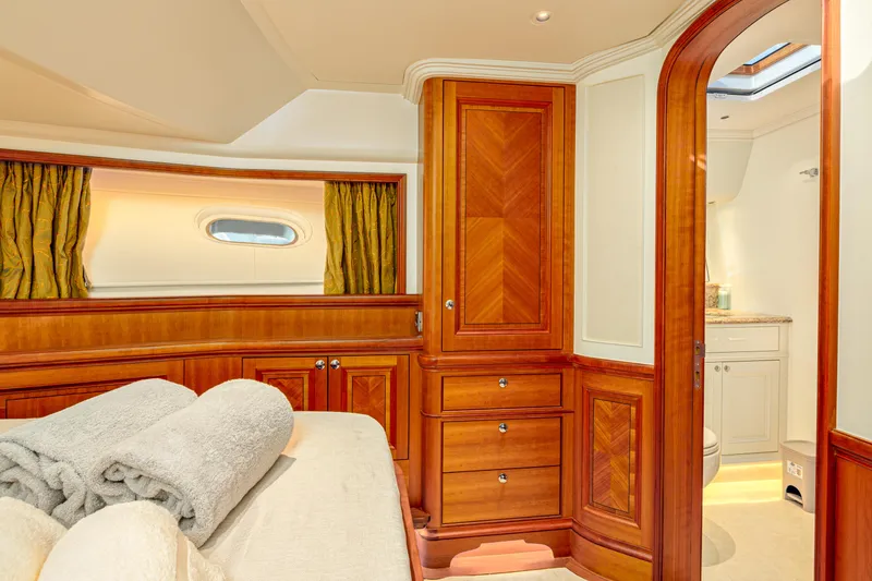 Frivolous Yacht Photos Pics Luxurious 2019 Hunt Yachts motor yacht cabin with elegant wood finish and cozy bedding.