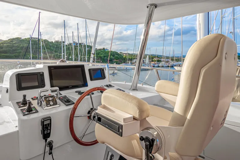 Frivolous Yacht Photos Pics 2019 Hunt Yachts motor yacht helm with navigation screens and steering wheel.