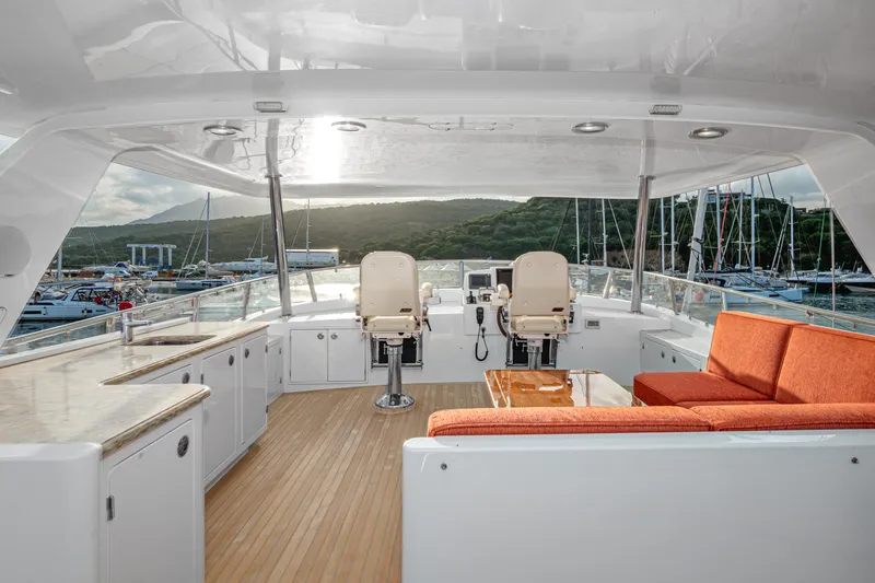 Frivolous Yacht Photos Pics Luxurious 2019 Hunt Yachts motor yacht interior with seating and helm, docked at marina.