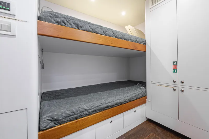 Frivolous Yacht Photos Pics Bunk beds in 2019 Hunt Yachts motor yacht cabin, featuring sleek design and storage.