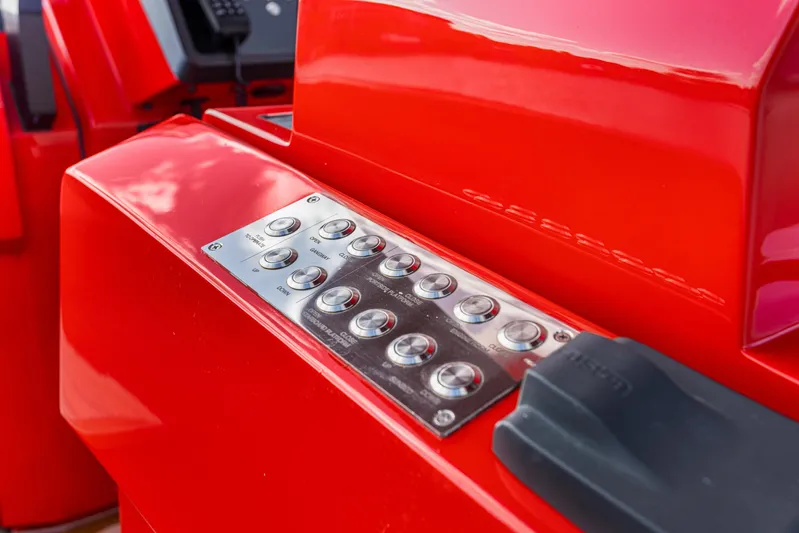 Corso Red Yacht Photos Pics Control panel of a 2021 Wally 48ft yacht, featuring sleek red design and metallic buttons.