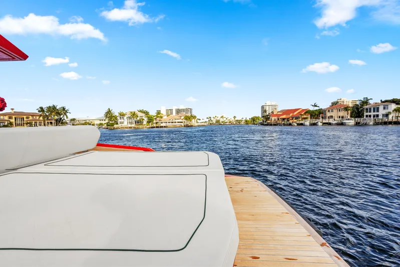 Corso Red Yacht Photos Pics Luxurious 2021 Wally 48ft yacht on serene waterfront with clear blue skies.