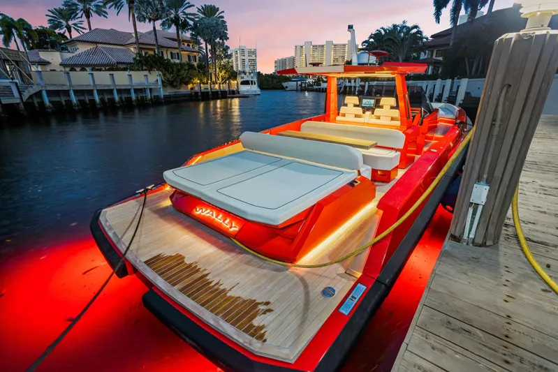 Corso Red Yacht Photos Pics Luxurious 2021 Wally 48ft yacht docked at sunset, featuring elegant lighting and modern design.
