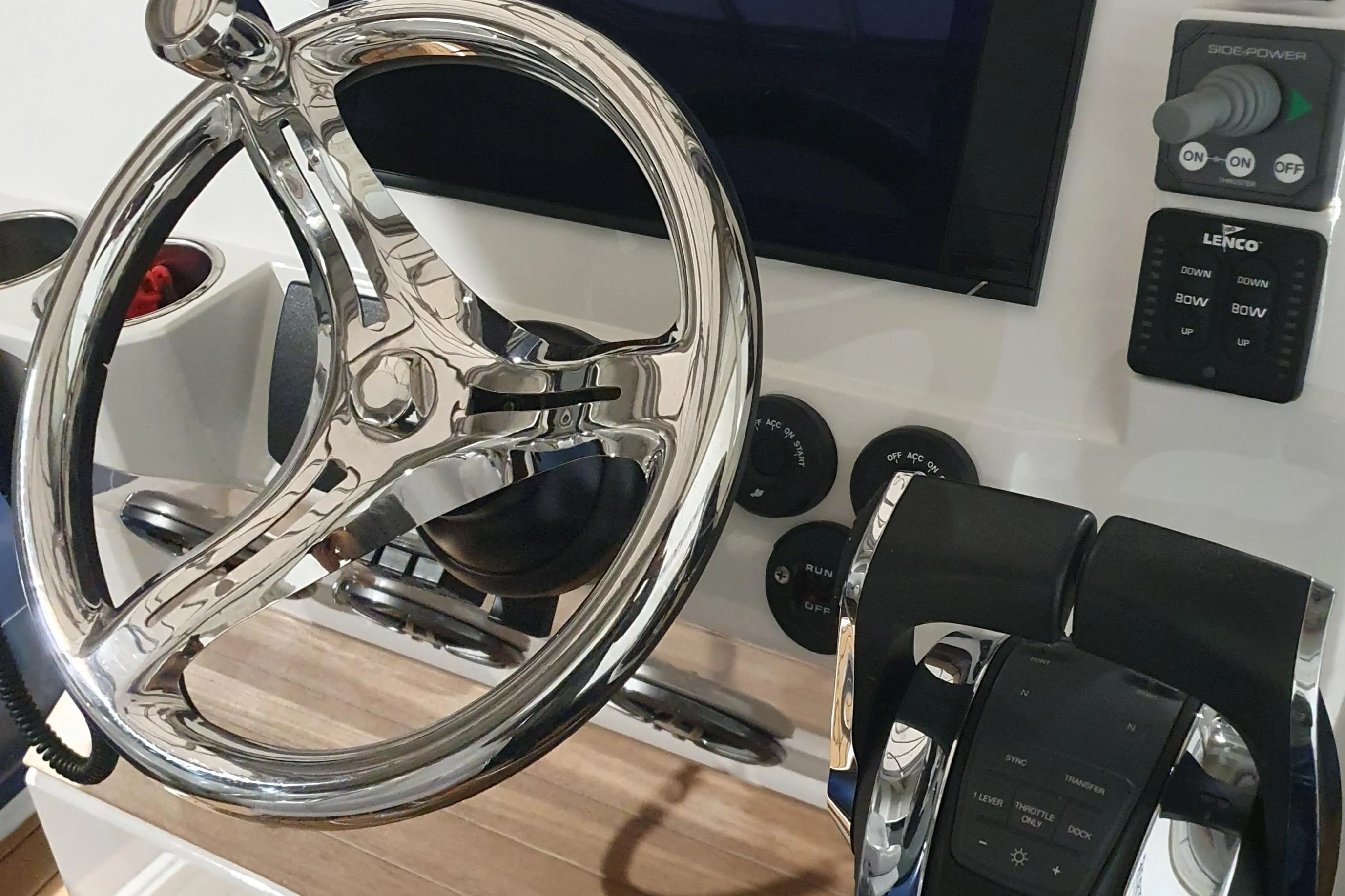 2023 Protector 330 boat helm with chrome steering wheel and control panel.