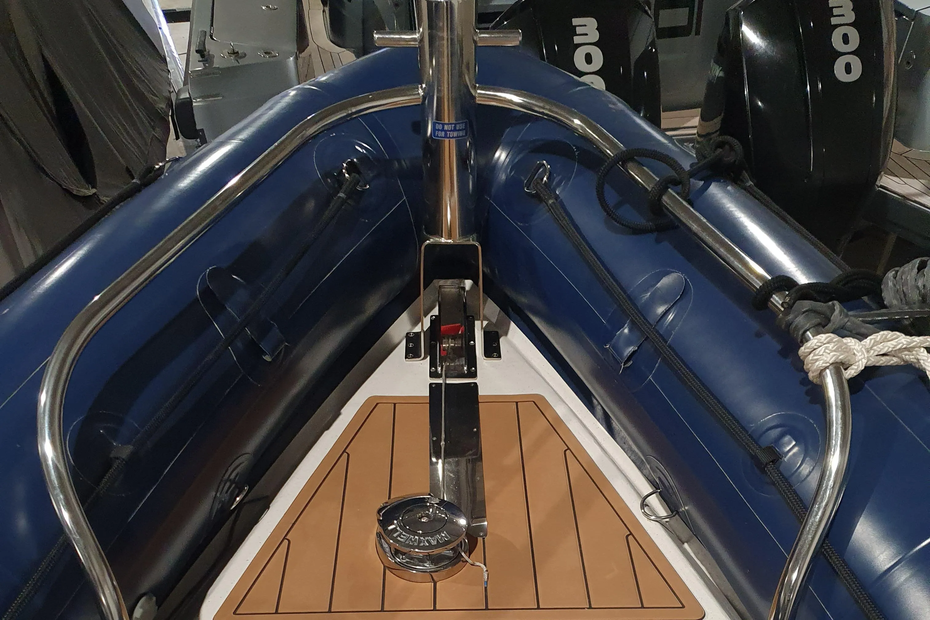 2023 Protector 330 boat interior with blue inflatable sides and wooden deck.