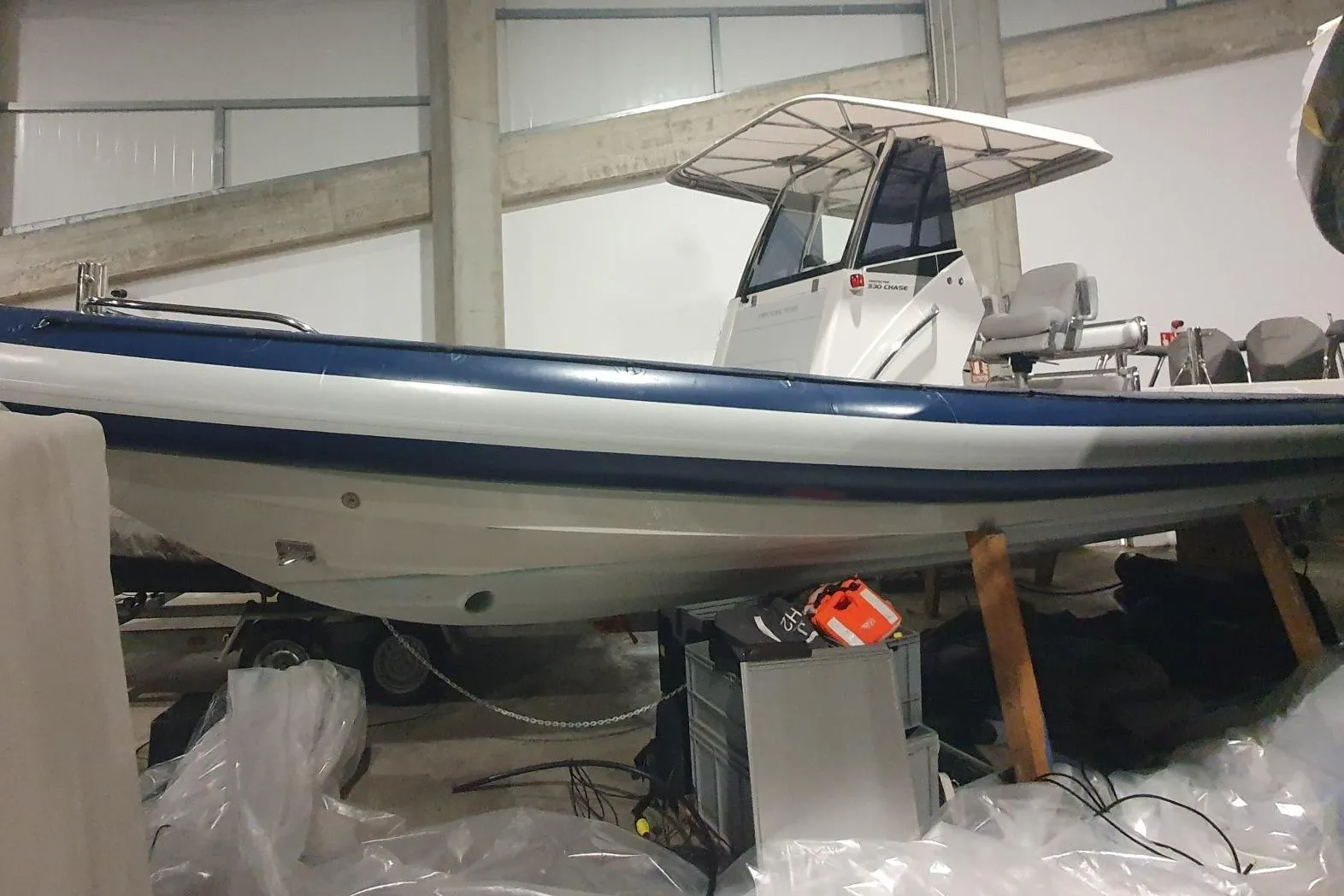 2023 Protector 330 boat in storage, featuring a sleek design and sturdy build.