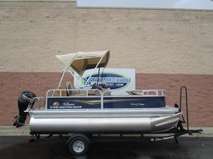 2025 Sun Tracker Bass Buggy 16 pontoon boat on trailer at marina.