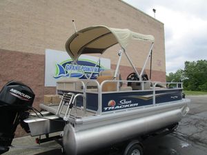 2025 Sun Tracker Bass Buggy 16 pontoon boat with canopy and Mercury engine.