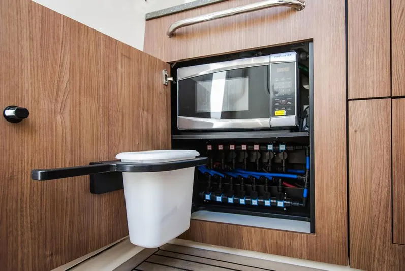  Yacht Photos Pics Manufacturer Provided Image: Microwave and electrical panel in 2014 Boston Whaler 350 Outrage boat kitchen.