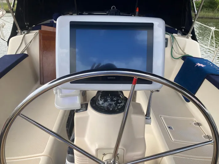 Enabled Yacht Photos Pics Steering wheel and navigation system on 1999 Island Packet 350 sailboat.