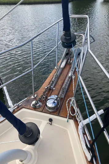 Enabled Yacht Photos Pics 1999 Island Packet 350 sailboat bow with anchor and railing on calm water.