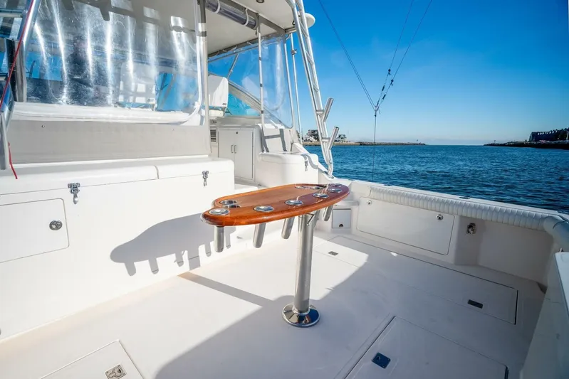 Moondawg Yacht Photos Pics 2007 Cabo 40 Express yacht deck with ocean view and fishing rod holders.