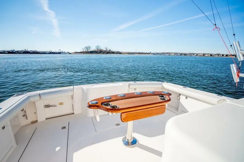 Moondawg Yacht Photos Pics 2007 Cabo 40 Express boat deck with ocean view and fishing rod holders.