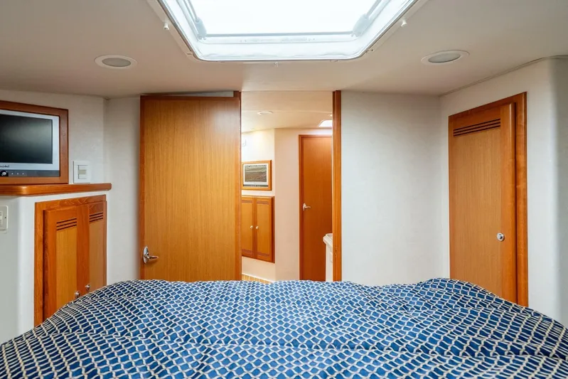 Moondawg Yacht Photos Pics Interior cabin of 2007 Cabo 40 Express yacht with wood finishes and skylight.