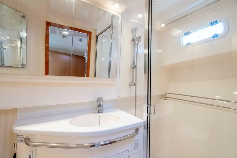 Moondawg Yacht Photos Pics Luxurious bathroom in 2007 Cabo 40 Express yacht with modern fixtures and shower.