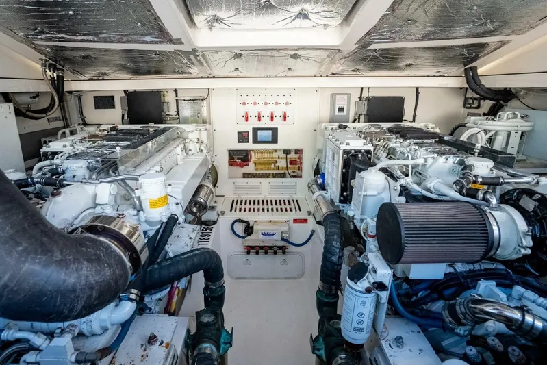 Moondawg Yacht Photos Pics Engine room of 2007 Cabo 40 Express yacht, showcasing dual engines and control systems.