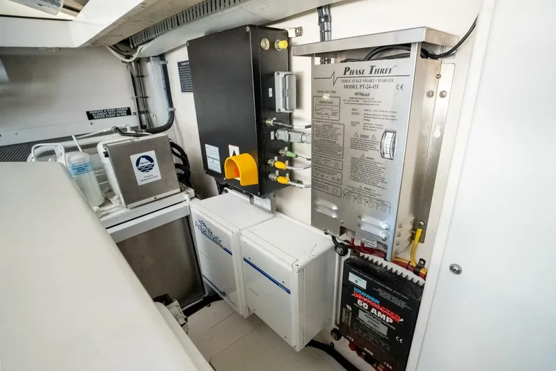 Moondawg Yacht Photos Pics Engine room of 2007 Cabo 40 Express with electrical systems and components.