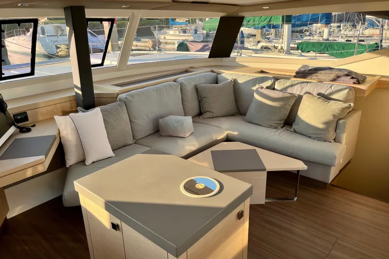 Bright Side Yacht Photos Pics Luxurious interior of 2018 Fountaine Pajot Saona catamaran with plush seating and modern decor.