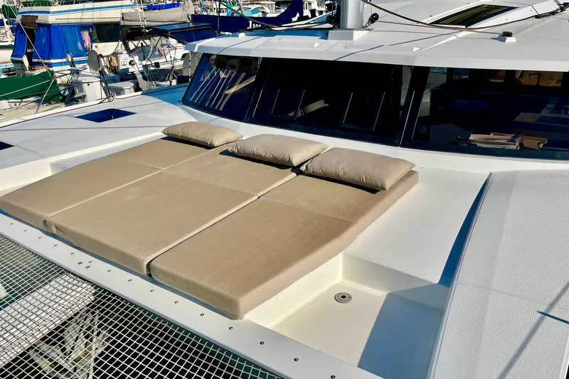 Bright Side Yacht Photos Pics 2018 Fountaine Pajot Saona catamaran with sunbathing cushions on deck.