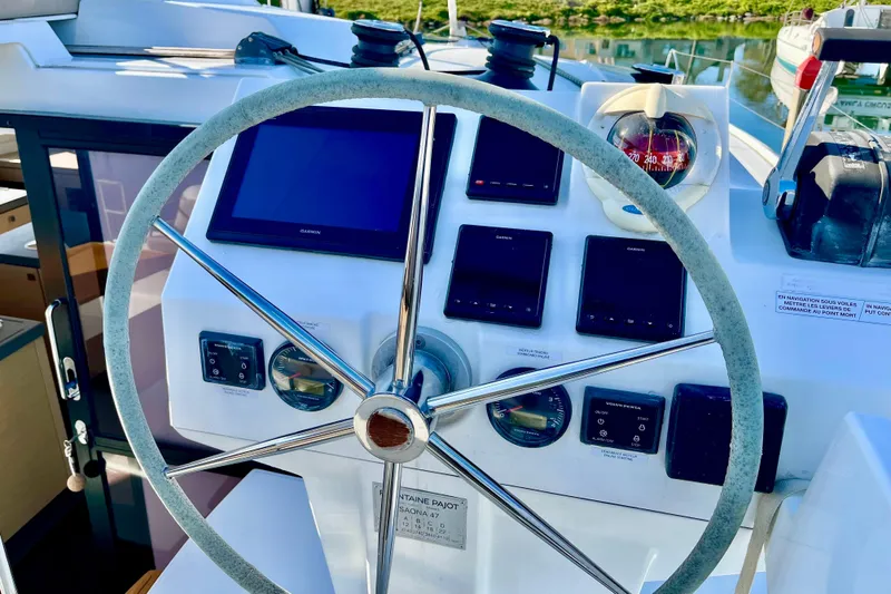 Bright Side Yacht Photos Pics Helm of 2018 Fountaine Pajot Saona catamaran with navigation instruments and compass.