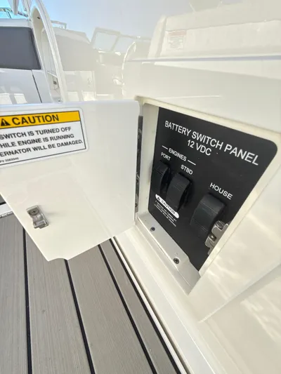 The Good Stuff Yacht Photos Pics Battery switch panel on 2023 Sea Ray SLX 310 OB boat, showing caution label.