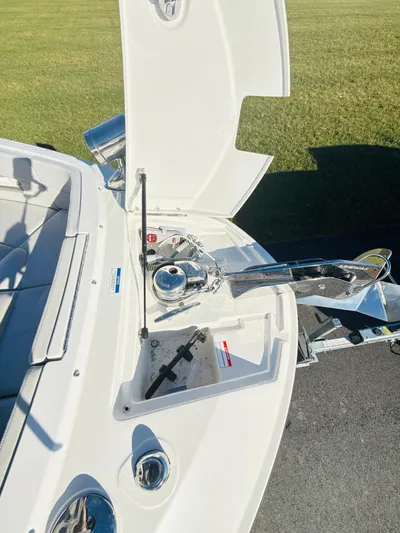 The Good Stuff Yacht Photos Pics 2023 Sea Ray SLX 310 OB boat anchor compartment with open hatch on a sunny day.