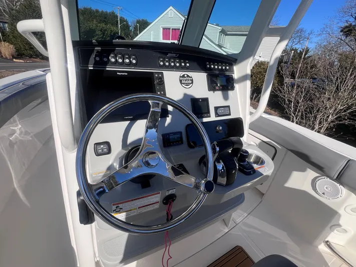  Yacht Photos Pics 2022 Boston Whaler 280 Outrage helm with steering wheel and control panel.