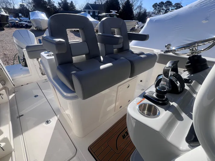 Yacht Photos Pics 2022 Boston Whaler 280 Outrage boat interior with dual seating and control panel.