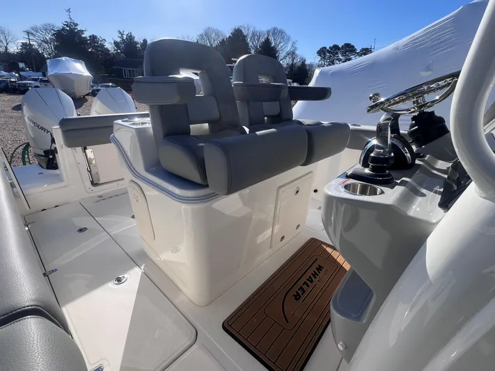  Yacht Photos Pics 2022 Boston Whaler 280 Outrage boat interior with dual seats and control panel.