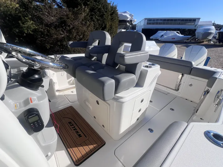  Yacht Photos Pics 2022 Boston Whaler 280 Outrage boat interior with dual helm seats and steering wheel.