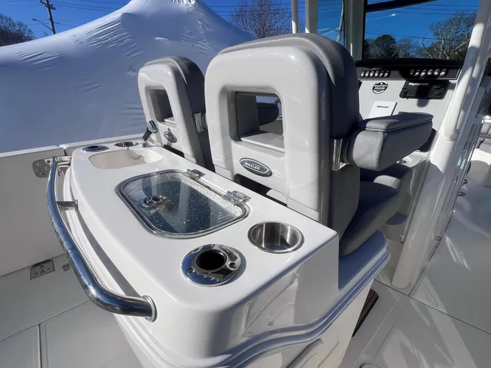  Yacht Photos Pics 2022 Boston Whaler 280 Outrage boat interior with seating and console details.