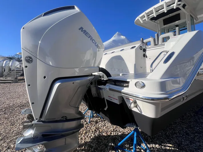  Yacht Photos Pics 2022 Boston Whaler 280 Outrage with Mercury outboard engine, displayed on stands.