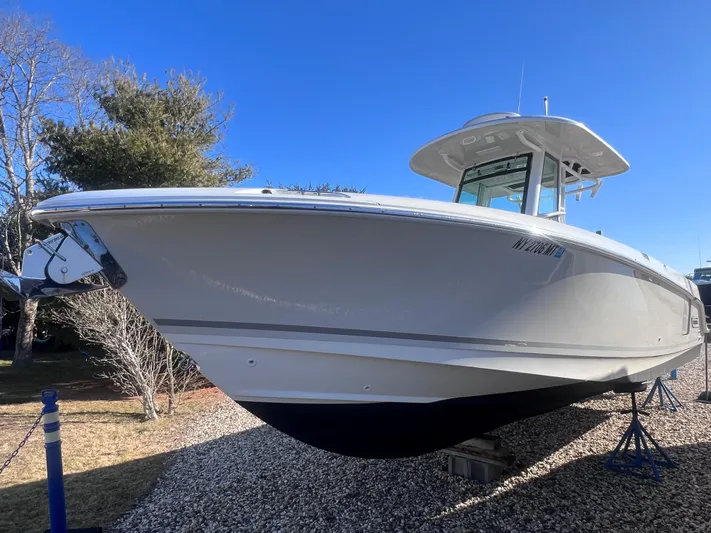  Yacht Photos Pics 2022 Boston Whaler 280 Outrage boat on display outdoors.