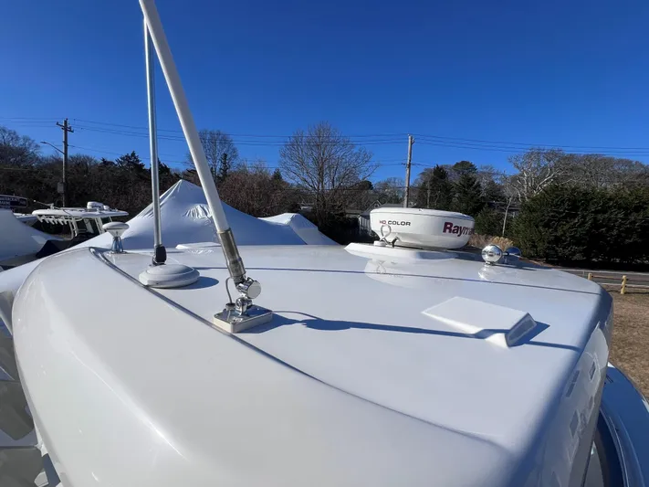  Yacht Photos Pics 2022 Boston Whaler 280 Outrage boat deck with radar equipment under clear blue sky.