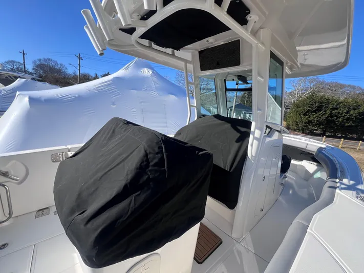  Yacht Photos Pics 2022 Boston Whaler 280 Outrage boat interior with covered seats and console.
