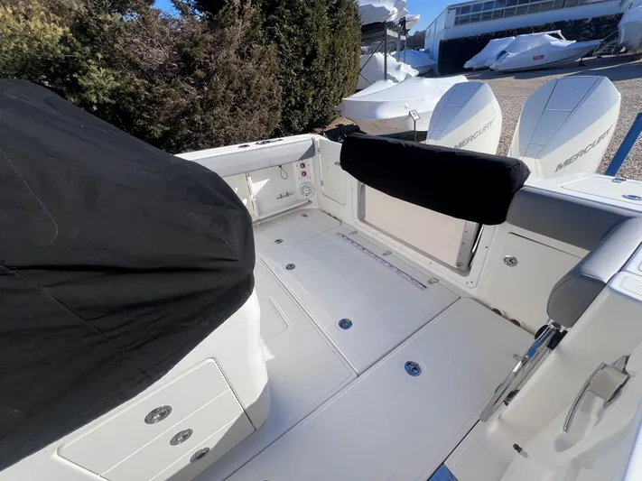  Yacht Photos Pics 2022 Boston Whaler 280 Outrage boat interior with covered seating and dual engines.