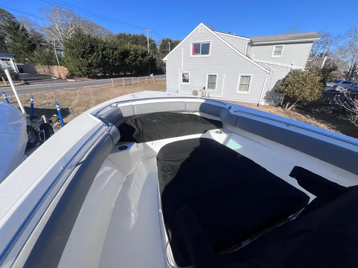  Yacht Photos Pics Boston Whaler 280 Outrage 2022 boat interior with seating, parked near a house.
