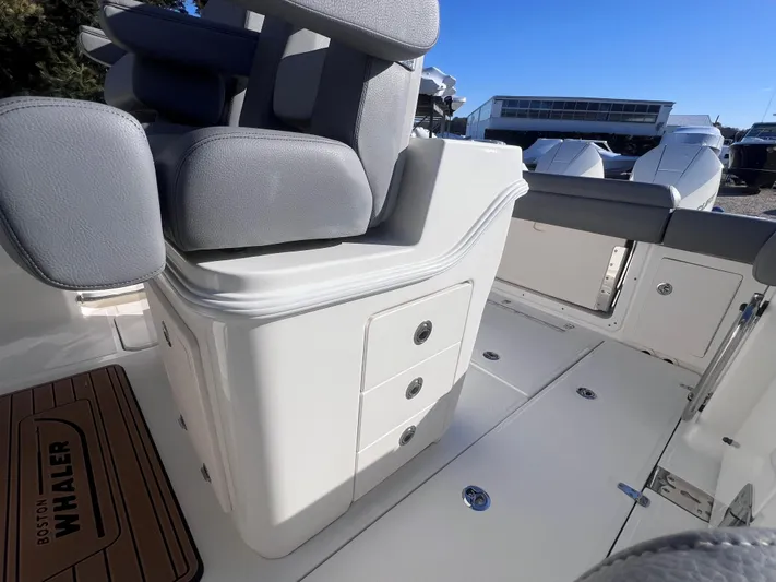  Yacht Photos Pics 2022 Boston Whaler 280 Outrage interior with seating and storage compartments.