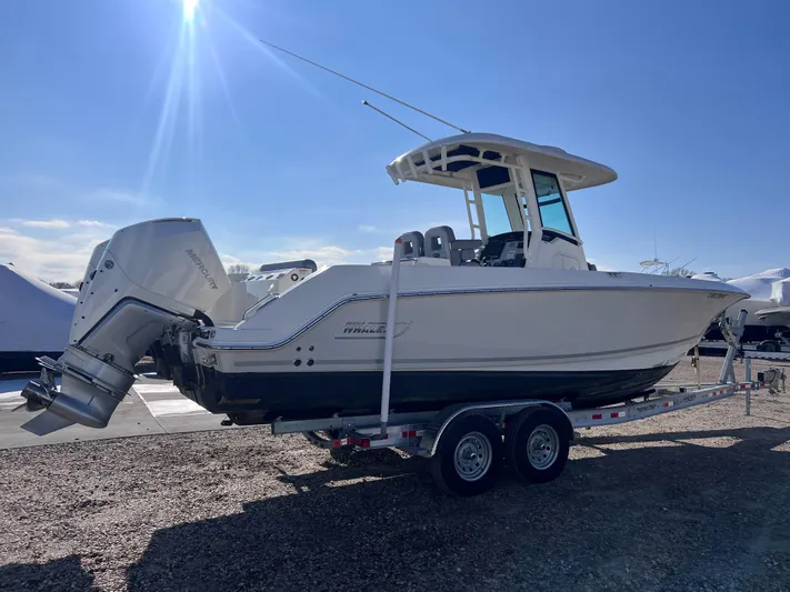 Yacht Photos Pics 2022 Boston Whaler 280 Outrage boat on trailer, side view, sunny day.