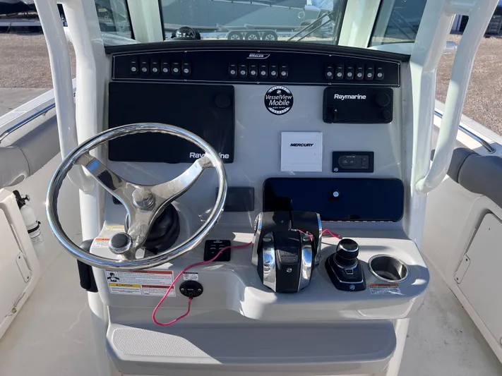  Yacht Photos Pics 2022 Boston Whaler 280 Outrage helm with steering wheel and navigation controls.