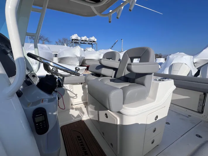  Yacht Photos Pics 2022 Boston Whaler 280 Outrage boat interior with dual seating and steering console.